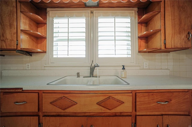 kitchen featuring a sink, a wealth of natural light, open shelves, and light countertops