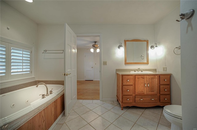 full bath with toilet, a jetted tub, vanity, and tile patterned floors