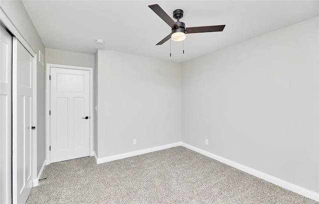 unfurnished bedroom with ceiling fan, carpet floors, a closet, and baseboards