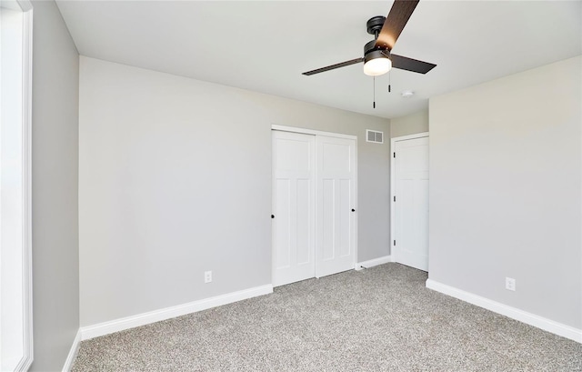 unfurnished bedroom with ceiling fan, carpet flooring, visible vents, baseboards, and a closet