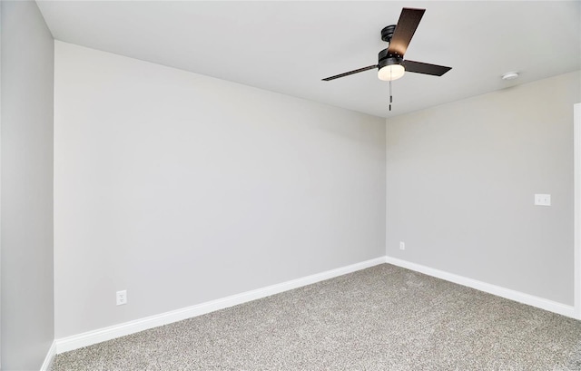 carpeted empty room featuring baseboards and a ceiling fan