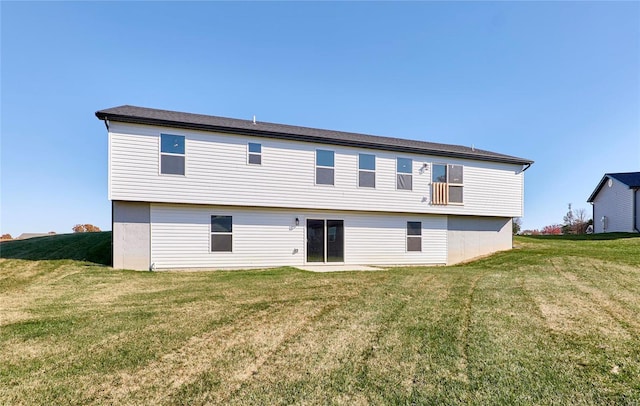 rear view of property featuring a yard