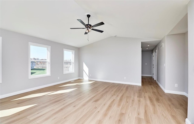 unfurnished living room featuring light wood-type flooring, visible vents, baseboards, and vaulted ceiling