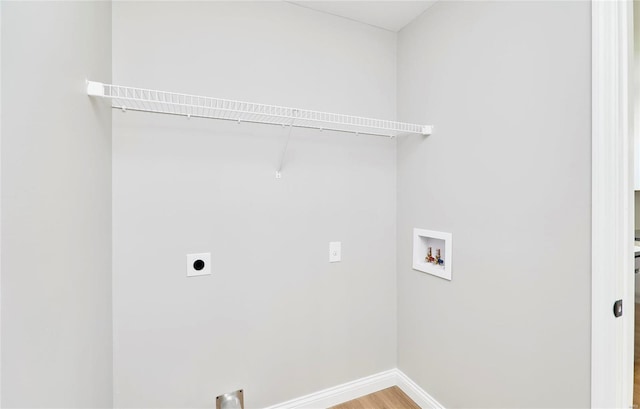 washroom featuring washer hookup, hookup for an electric dryer, wood finished floors, laundry area, and baseboards