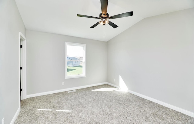 unfurnished room with vaulted ceiling, ceiling fan, baseboards, and light colored carpet