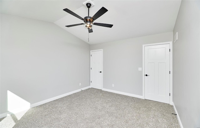 unfurnished bedroom featuring a ceiling fan, carpet, vaulted ceiling, and baseboards