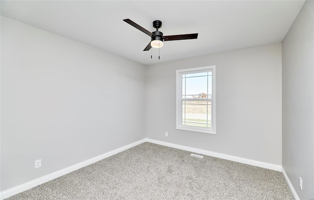 spare room with a ceiling fan, visible vents, baseboards, and carpet flooring