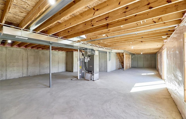 unfinished basement featuring heating unit