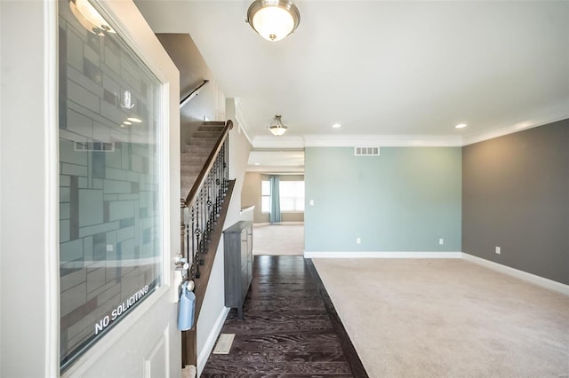 interior space with stairs, dark colored carpet, visible vents, and baseboards