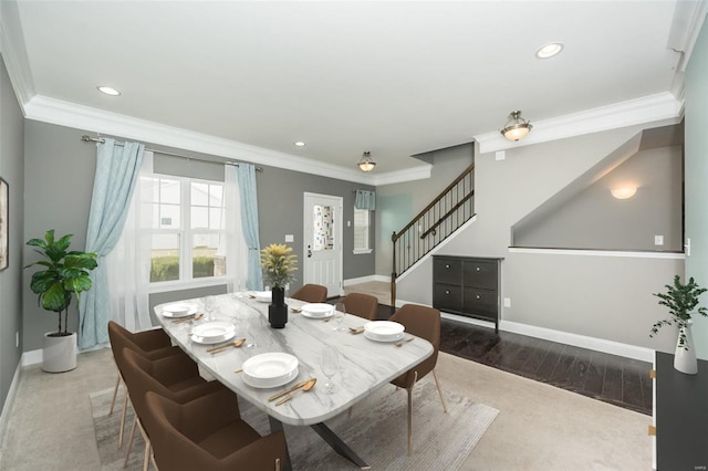 dining room with ornamental molding, stairway, baseboards, and wood finished floors