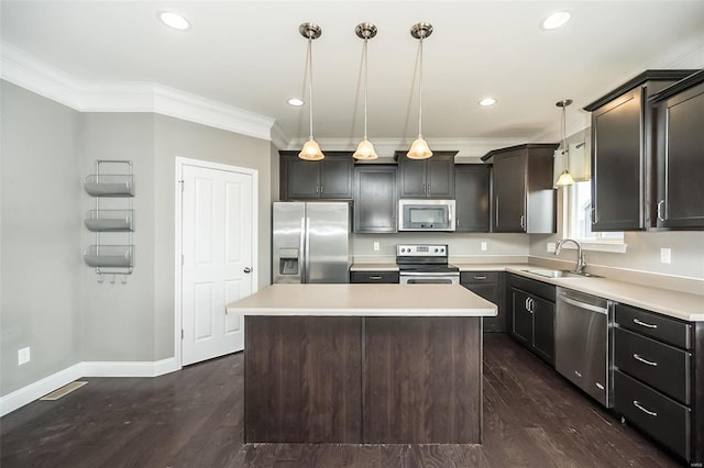 kitchen with dark wood-style floors, crown molding, appliances with stainless steel finishes, a sink, and baseboards