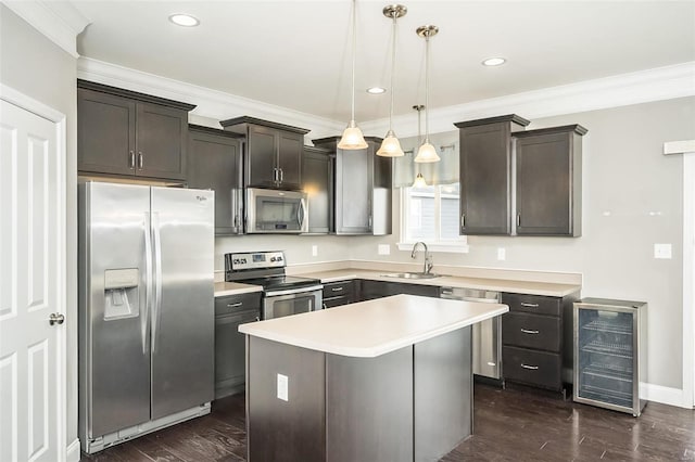 kitchen with beverage cooler, stainless steel appliances, dark wood-style flooring, a sink, and ornamental molding