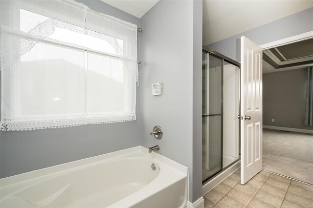 full bathroom featuring a garden tub, baseboards, a shower stall, and tile patterned floors