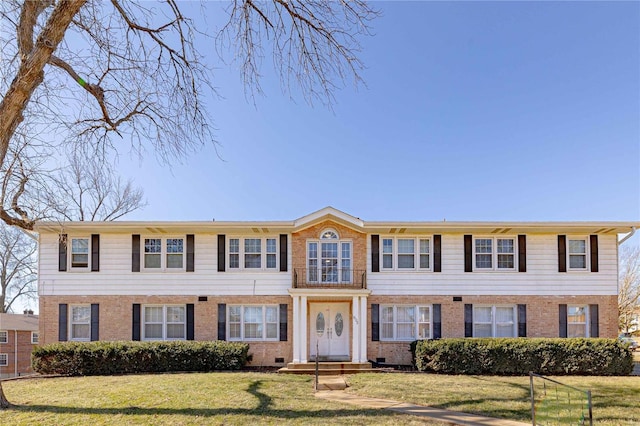 view of front of home featuring crawl space, a front yard, and brick siding