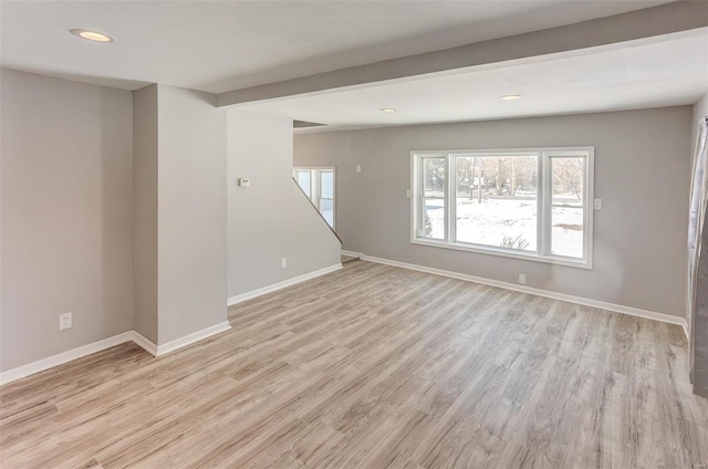 spare room with recessed lighting, light wood-style flooring, and baseboards