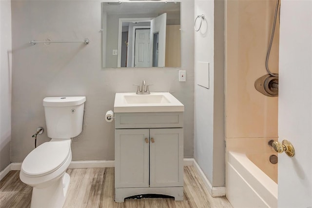 full bath with baseboards, vanity, toilet, and wood finished floors