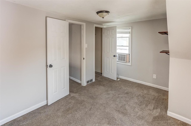 unfurnished bedroom featuring visible vents, baseboards, cooling unit, and light colored carpet