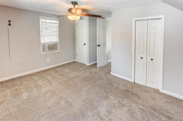 unfurnished bedroom featuring light carpet, ceiling fan, baseboards, and cooling unit