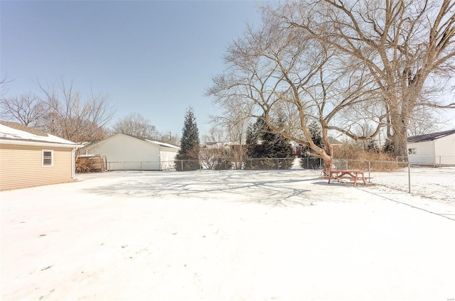 yard covered in snow featuring fence