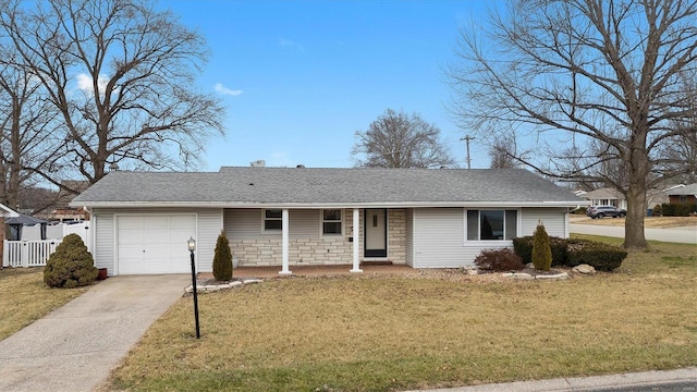 ranch-style house with a front yard, fence, a garage, stone siding, and driveway