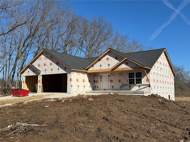 unfinished property with covered porch and a garage