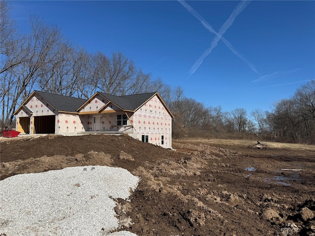 view of side of property featuring an attached garage