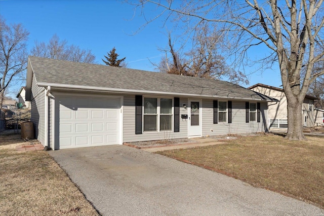 single story home with aphalt driveway, roof with shingles, an attached garage, and a front lawn