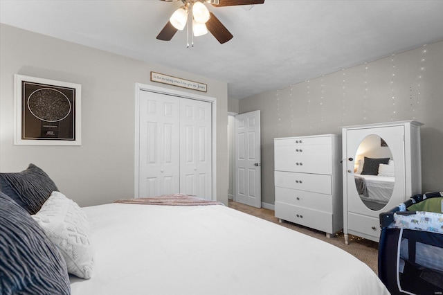 carpeted bedroom featuring ceiling fan and a closet