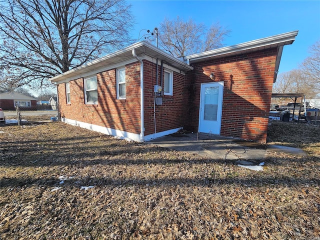 back of property featuring brick siding