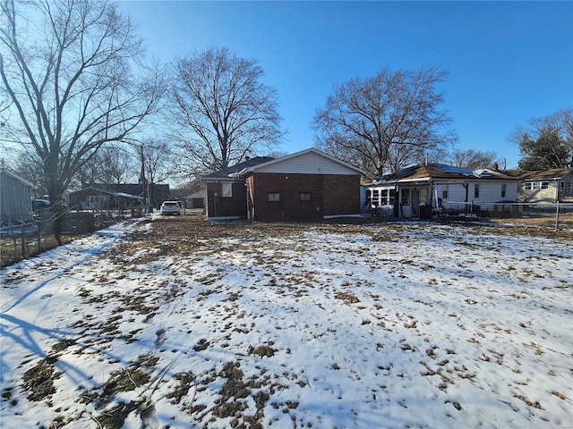 exterior space with brick siding and fence