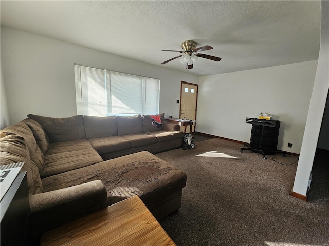 living area with a textured ceiling, carpet floors, ceiling fan, and baseboards