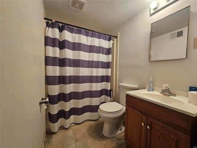 bathroom featuring toilet, vanity, visible vents, and a shower with curtain