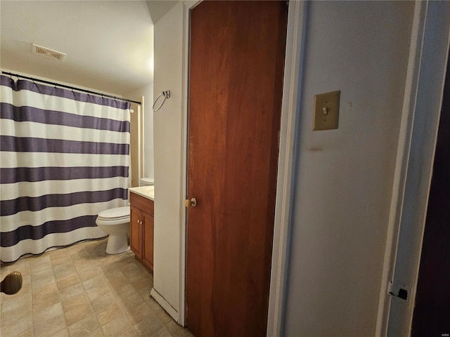 bathroom featuring toilet, visible vents, vanity, and tile patterned floors