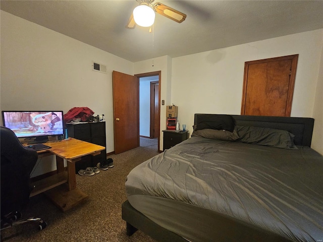 carpeted bedroom with visible vents and a ceiling fan