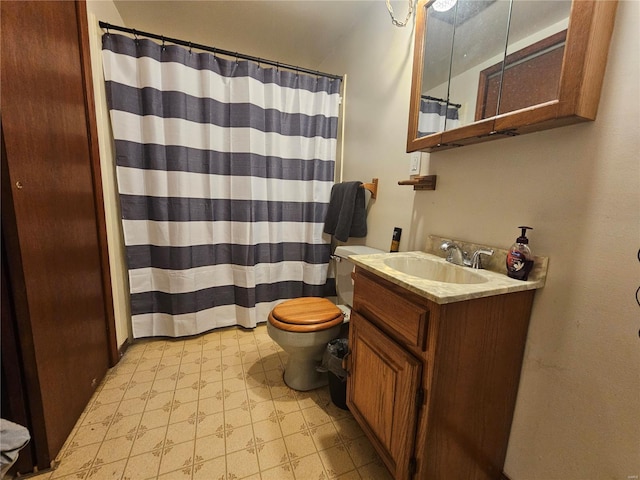 full bath with vanity, toilet, and tile patterned floors