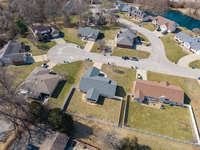 drone / aerial view featuring a water view and a residential view