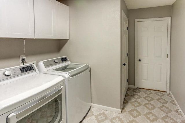 clothes washing area with light floors, washing machine and dryer, cabinet space, and baseboards