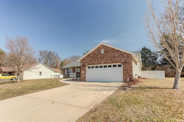 view of front of home with an attached garage, a front yard, concrete driveway, and brick siding