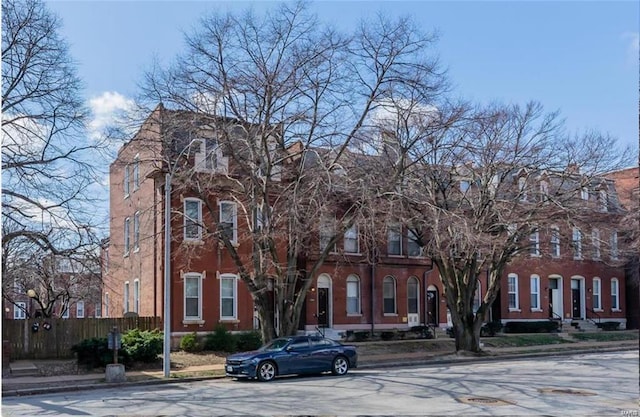 view of front of property featuring fence