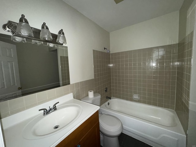 full bathroom with tub / shower combination, tile walls, toilet, and vanity