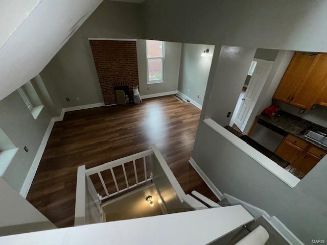 interior space featuring a fireplace, wood finished floors, and baseboards