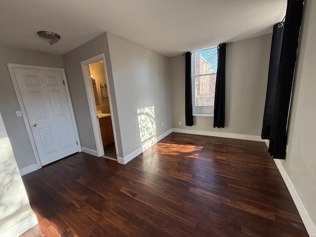 interior space featuring wood finished floors and baseboards