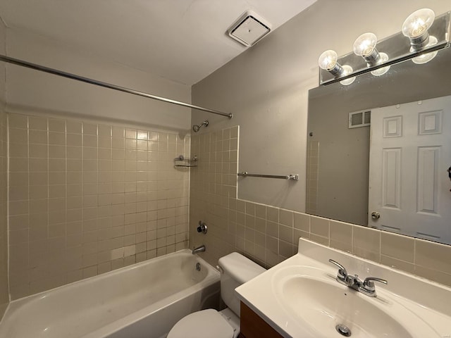 full bathroom featuring visible vents, shower / tub combination, tile walls, and toilet