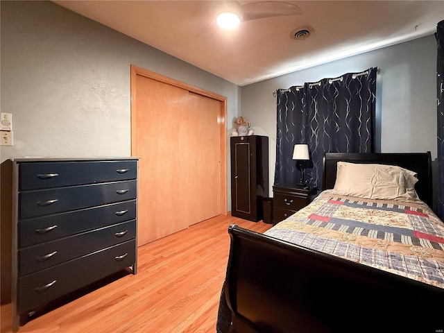 bedroom with light wood finished floors and visible vents