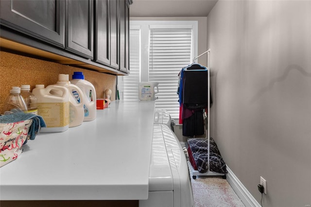 clothes washing area with baseboards