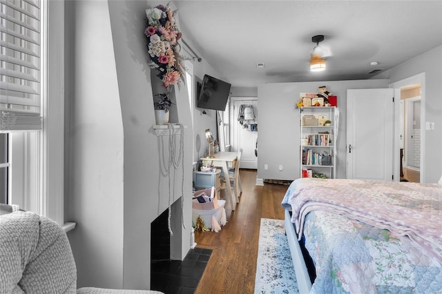 bedroom with dark wood-style flooring and visible vents