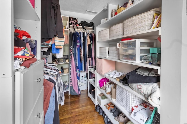 walk in closet featuring dark wood-style flooring and visible vents