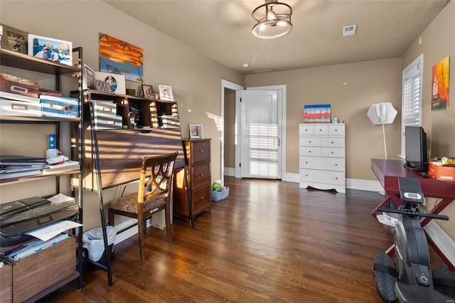 office with dark wood-type flooring, visible vents, and baseboards