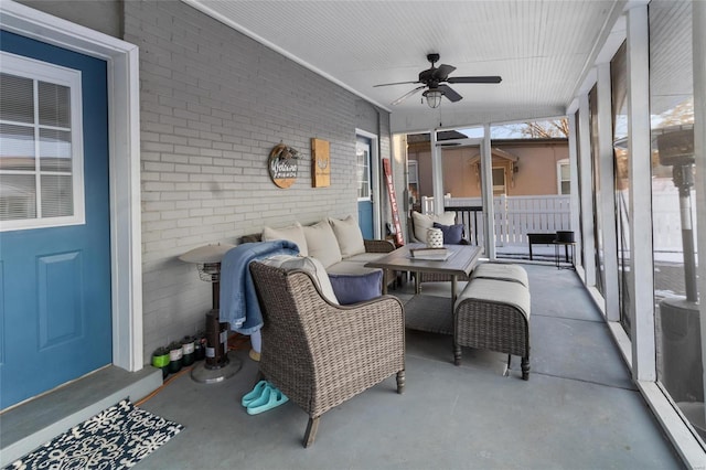 sunroom featuring ceiling fan