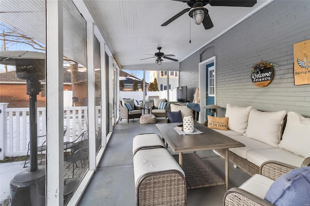 sunroom featuring ceiling fan